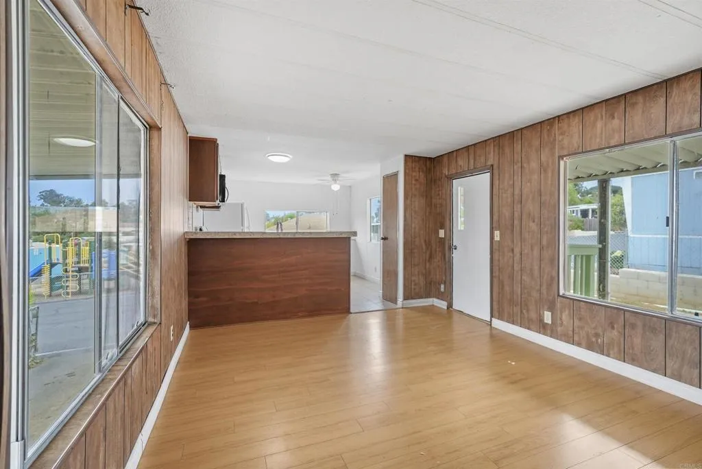 1455 Alturas Street, Unit 41 Fallbrook, CA 92028 - Photo 32 of 52 a view of a hallway with wooden floor and a kitchen