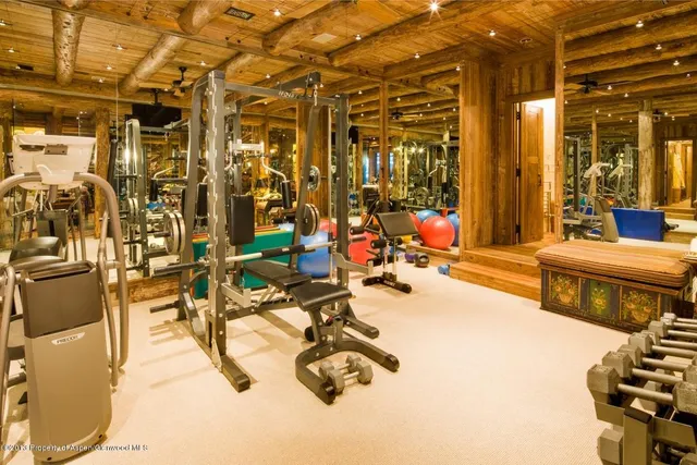 a spacious bedroom with a bed and glass door