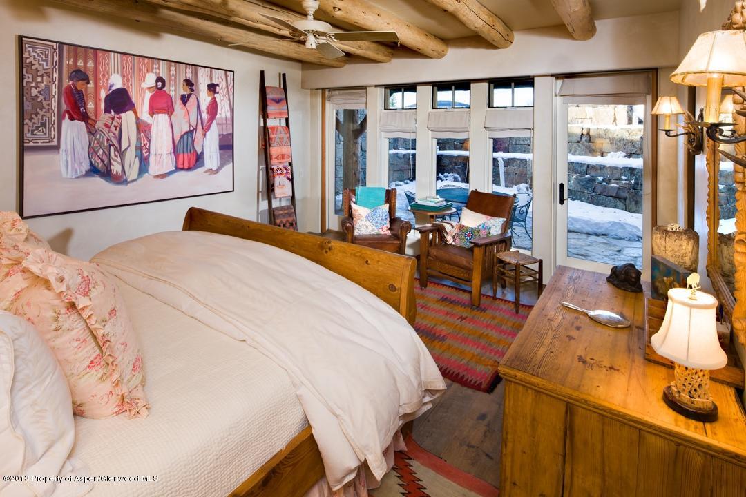 1100 McLain Flats Road Aspen, CO 81612 - Photo 24 of 50 a spacious bedroom with a bed and glass door