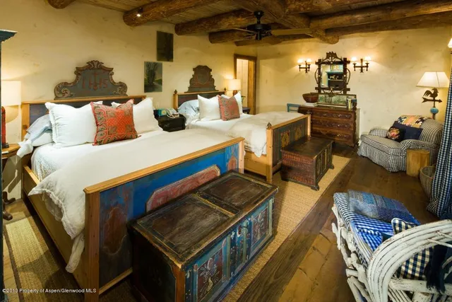 a bedroom with two beds and a walk in closet