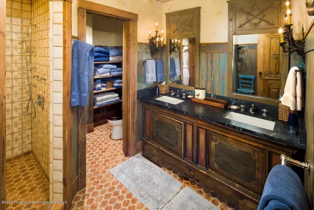 a view of a dining room with furniture large windows and a chandelier