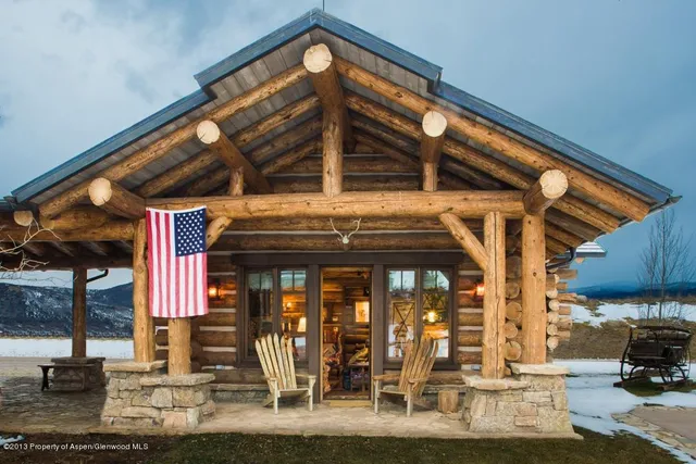 a bedroom with two beds and painting on the wall