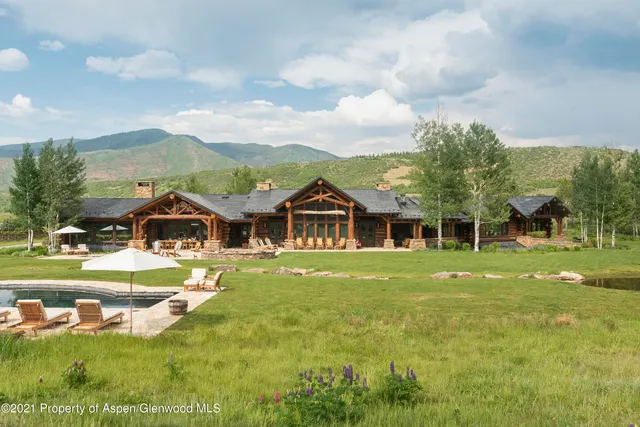 a view of a swimming pool and lounge chairs in patio