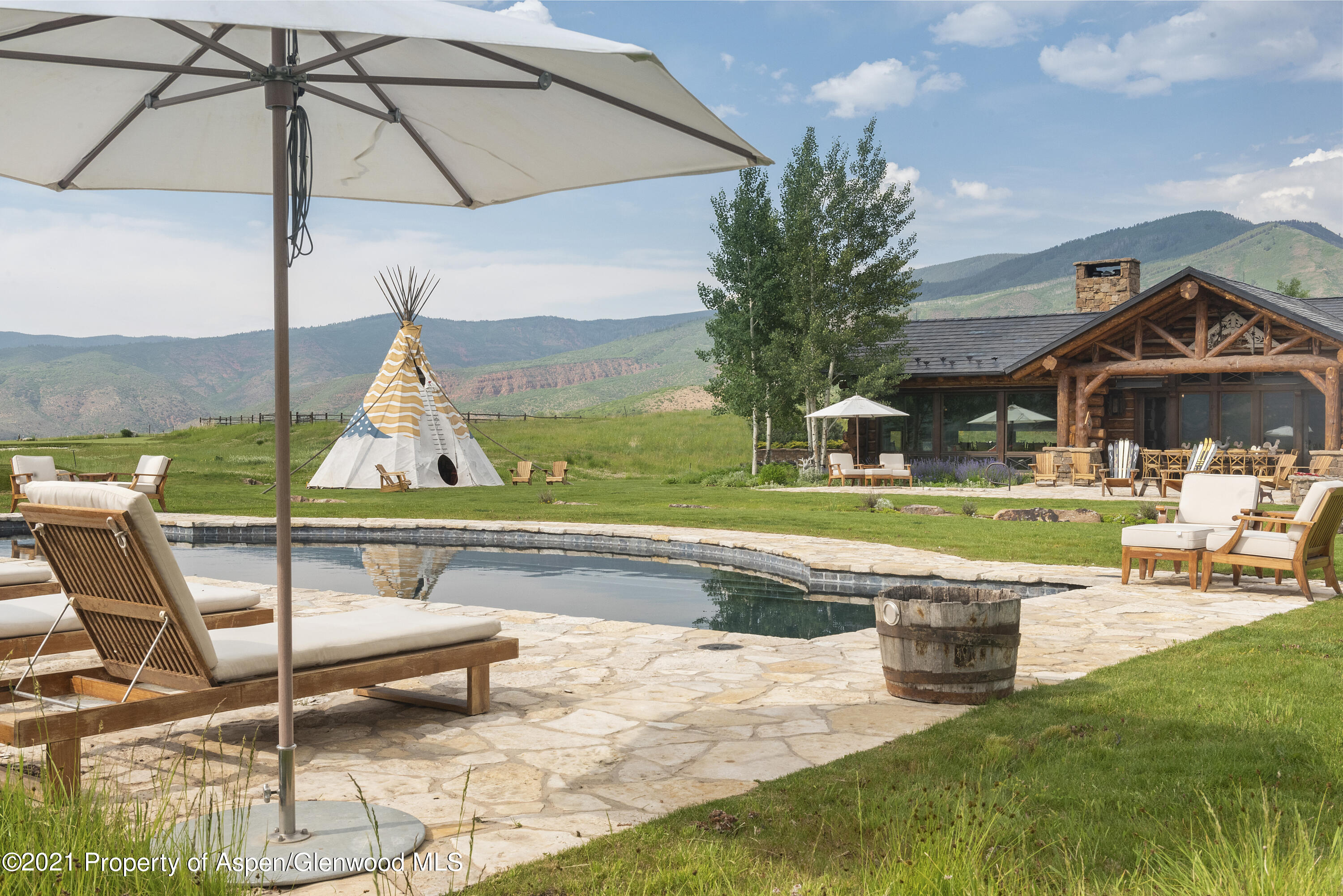 1100 McLain Flats Road Aspen, CO 81612 - Photo 40 of 50 a view of a swimming pool with a lounge chairs