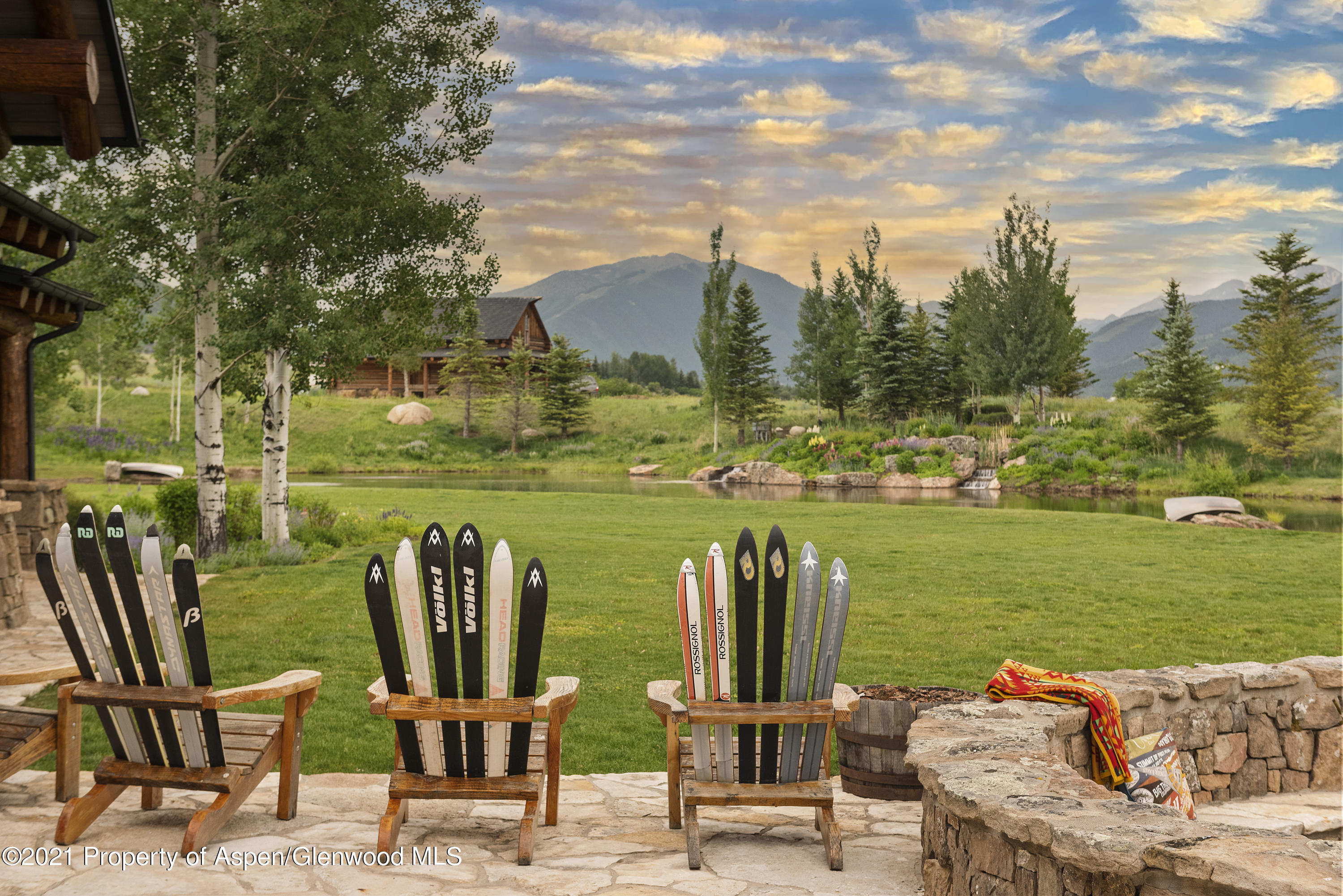 1100 McLain Flats Road Aspen, CO 81612 - Photo 4 of 50 a view of a lake with lawn chairs and a table
