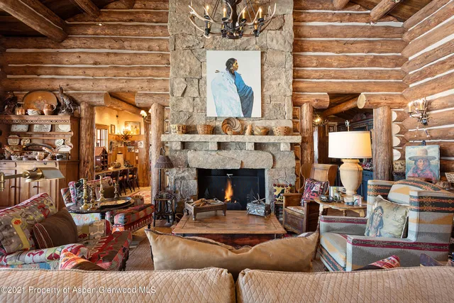a living room with lots of furniture and a chandelier