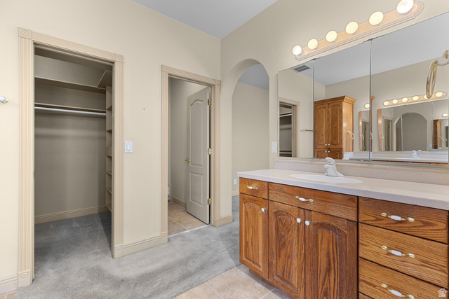389 North Main Street St. George, UT 84770 - Photo 17 of 44 Bathroom with a spacious closet, vanity, light colored carpet, and light tile patterned floors