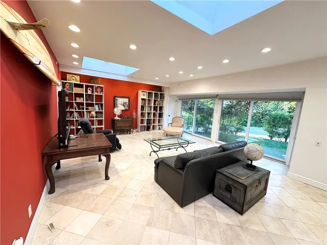 a living room with furniture a rug and white walls