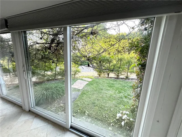 a view of a room with a large window and front door