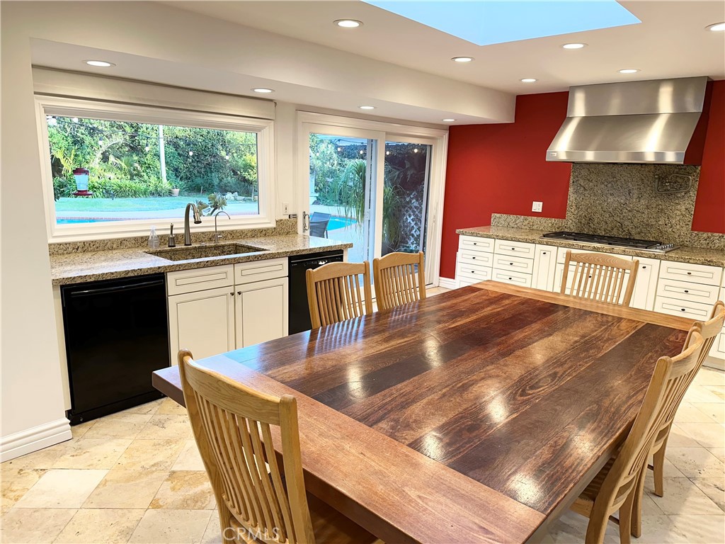 27424 Rainbow Ridge Road Palos Verdes Peninsula, CA 90274 - Photo 26 of 47 a kitchen with stainless steel appliances granite countertop a stove a sink a microwave dining table and chairs