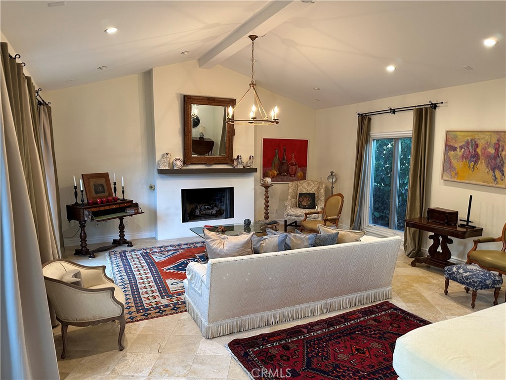 27424 Rainbow Ridge Road Palos Verdes Peninsula, CA 90274 - Photo 30 of 47 a living room with furniture a fireplace and a flat screen tv