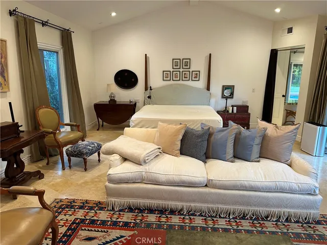 a bedroom with a bed and mirror