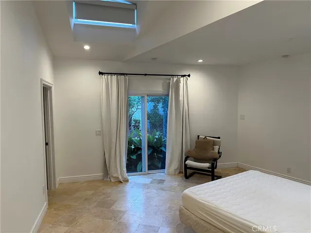 a bedroom with a bed and a chair