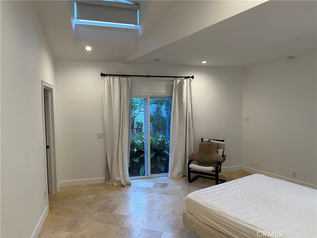 27424 Rainbow Ridge Road Palos Verdes Peninsula, CA 90274 - Photo 36 of 47 a bedroom with a bed and a chair