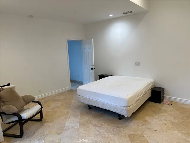 a bedroom with a bed and chair