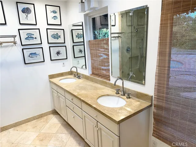 a bathroom with a granite countertop sink a toilet and a shower