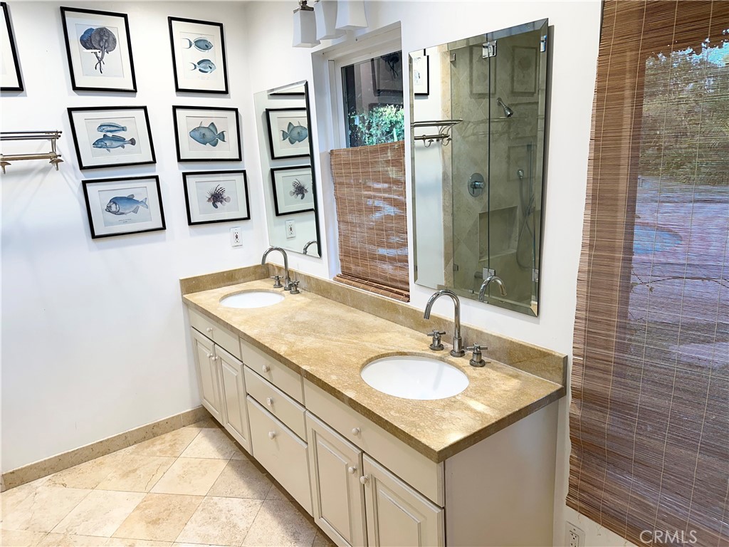 27424 Rainbow Ridge Road Palos Verdes Peninsula, CA 90274 - Photo 40 of 47 a bathroom with a granite countertop sink a mirror a shower and a bathroom