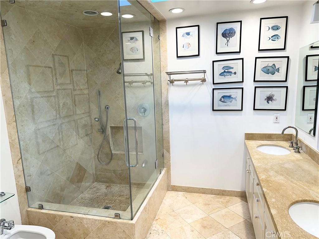 27424 Rainbow Ridge Road Palos Verdes Peninsula, CA 90274 - Photo 41 of 47 a bathroom with a granite countertop sink a toilet and a shower