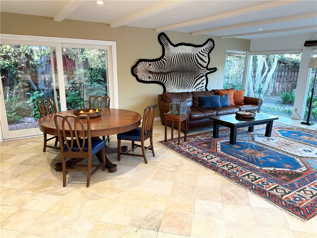 27424 Rainbow Ridge Road Palos Verdes Peninsula, CA 90274 - Photo 10 of 47 a dining room with furniture a rug and a floor to ceiling window