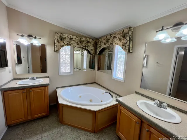 a bathroom with a tub sink and mirror