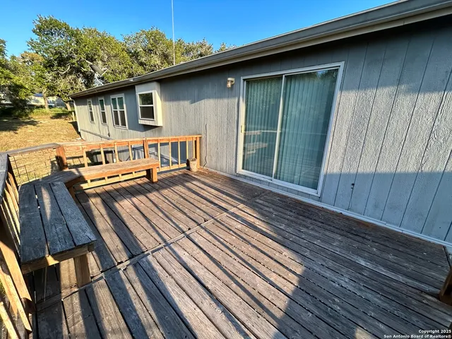 a view of a wooden deck with a yard