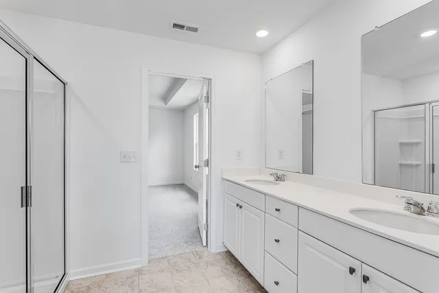 a bathroom with a double vanity sink and mirror