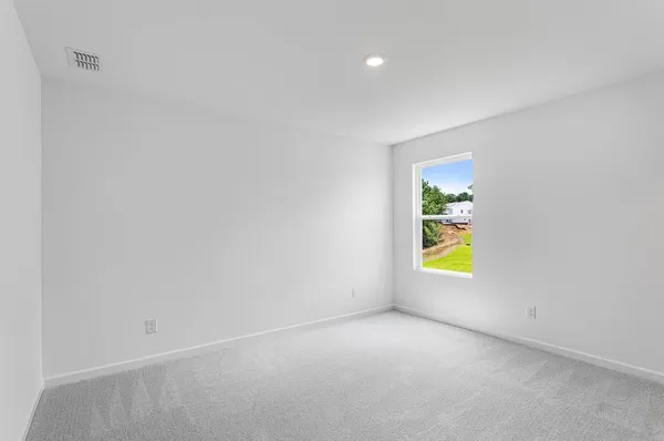 a view of an empty room and a window