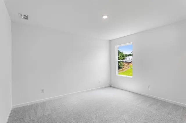 a view of an empty room and a window