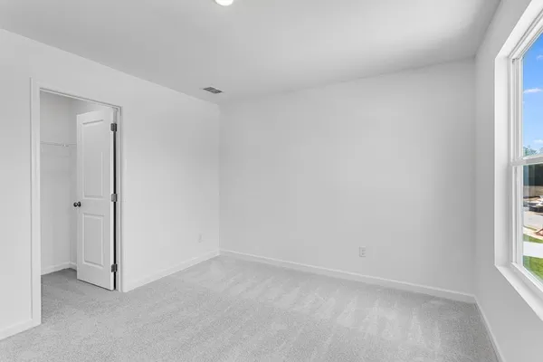 a view of an empty room and a window