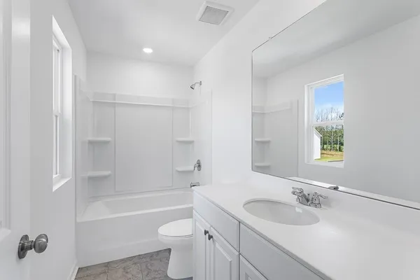 a bathroom with a sink toilet tub and shower