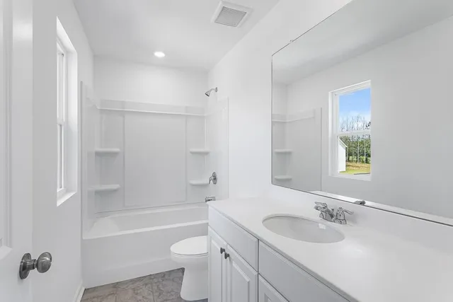 a bathroom with a sink toilet tub and shower