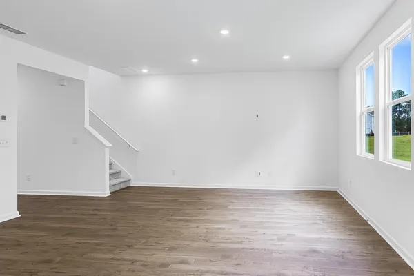 a view of room with window and wooden floor
