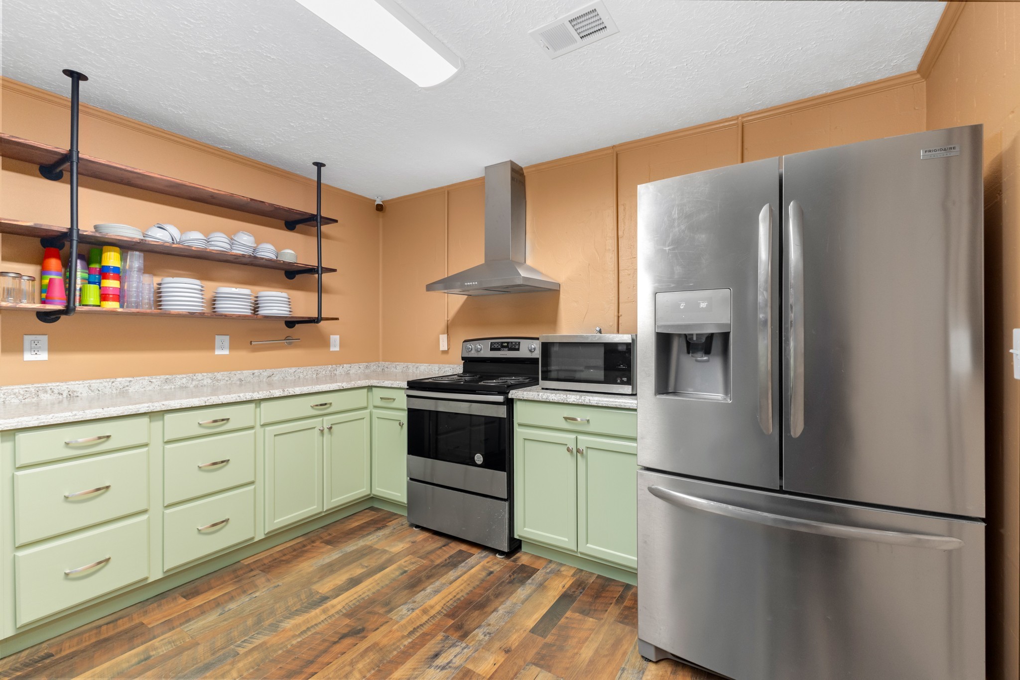 427 South Fair Street Morrison, TN 37357 - Photo 19 of 44 a kitchen with granite countertop stainless steel appliances and wooden floor
