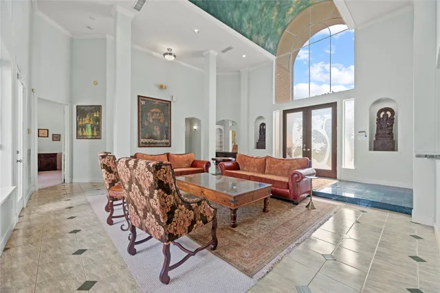 a view of a house with a big yard plants and large trees