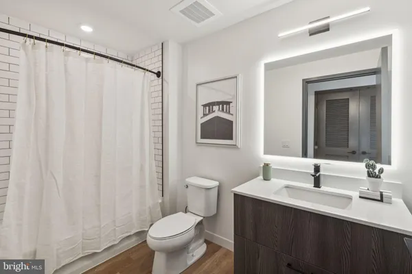 a bathroom with a toilet a sink and a mirror