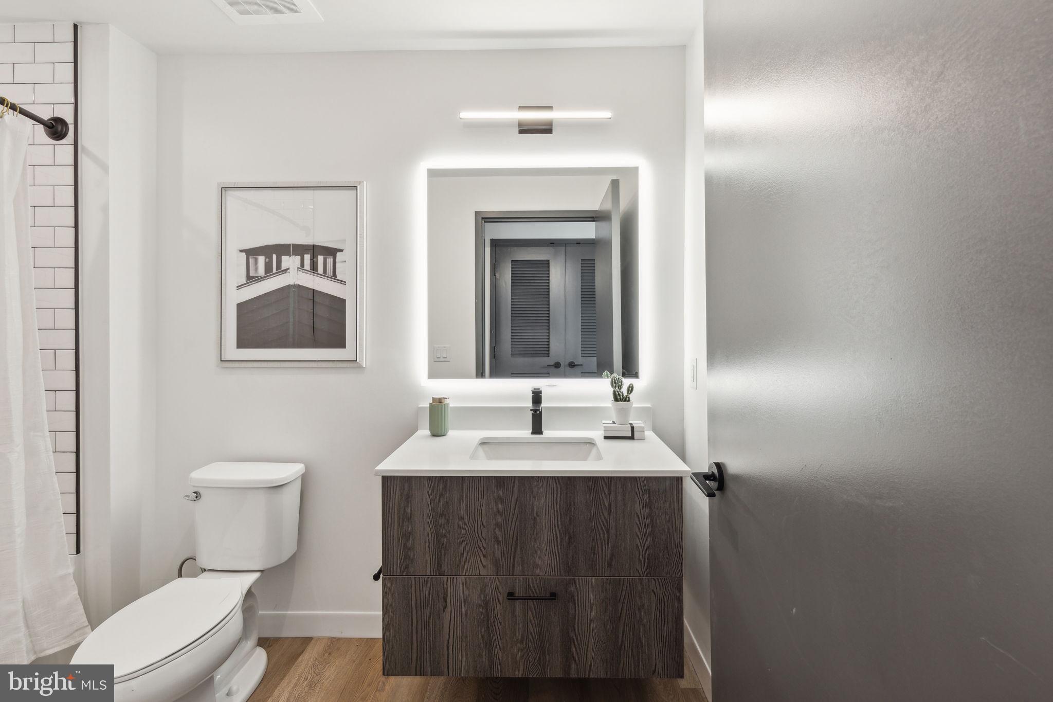 1122 Frankford Avenue, Unit STUDIO A2 Philadelphia, PA 19125 - Photo 11 of 45 a bathroom with a toilet sink and mirror