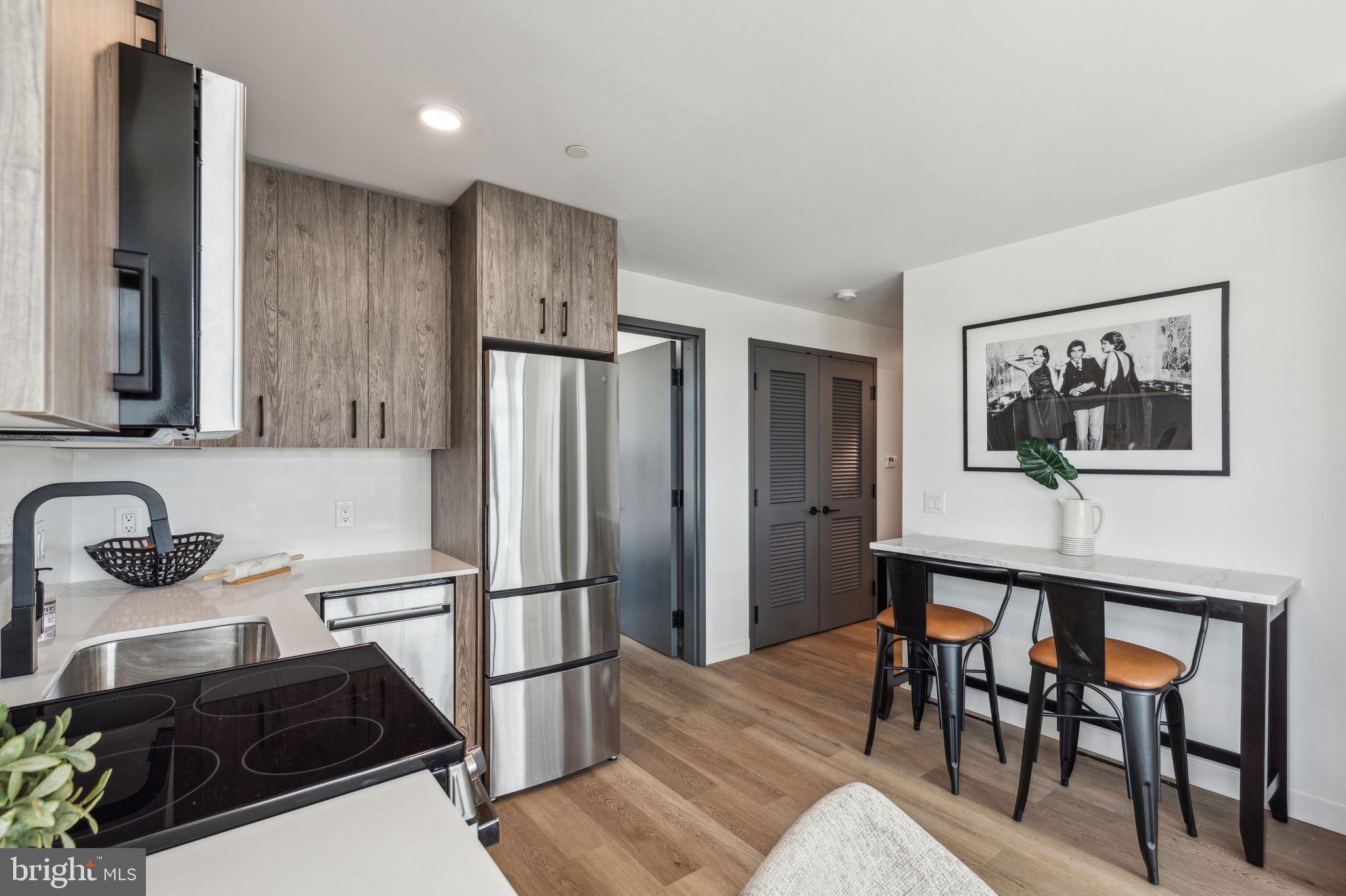 1122 Frankford Avenue, Unit STUDIO A2 Philadelphia, PA 19125 - Photo 2 of 45 a kitchen with stainless steel appliances granite countertop a refrigerator and a stove top oven