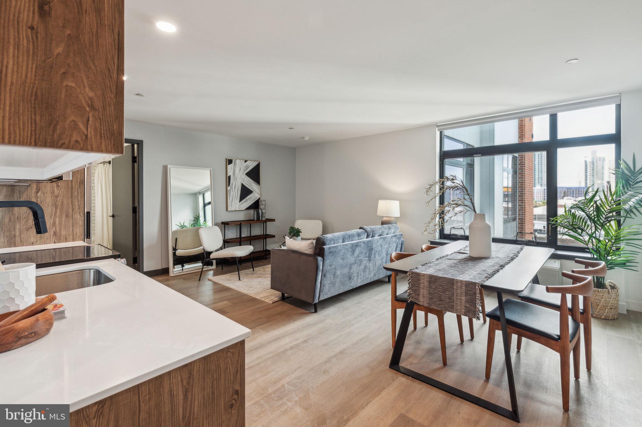 1122 Frankford Avenue, Unit STUDIO A2 Philadelphia, PA 19125 - Photo 22 of 45 a living room with furniture a table and a large window