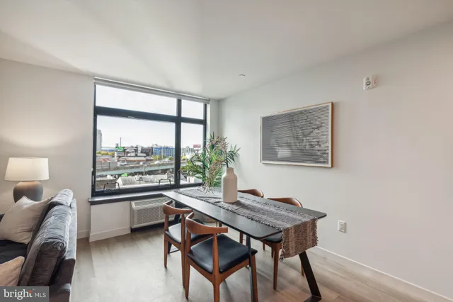 a living room with furniture and a kitchen view