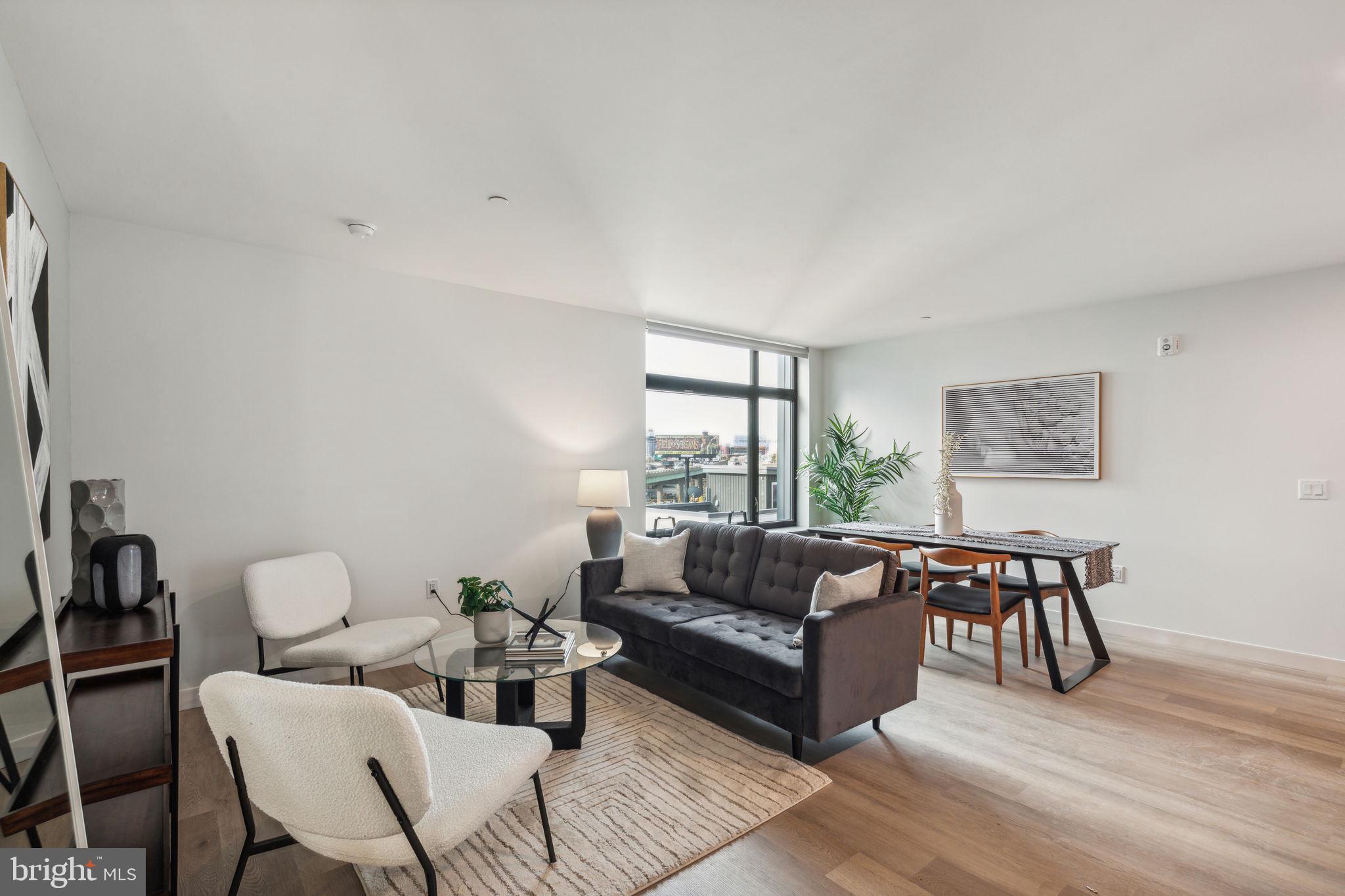 1122 Frankford Avenue, Unit STUDIO A2 Philadelphia, PA 19125 - Photo 25 of 45 a living room with furniture and a large window
