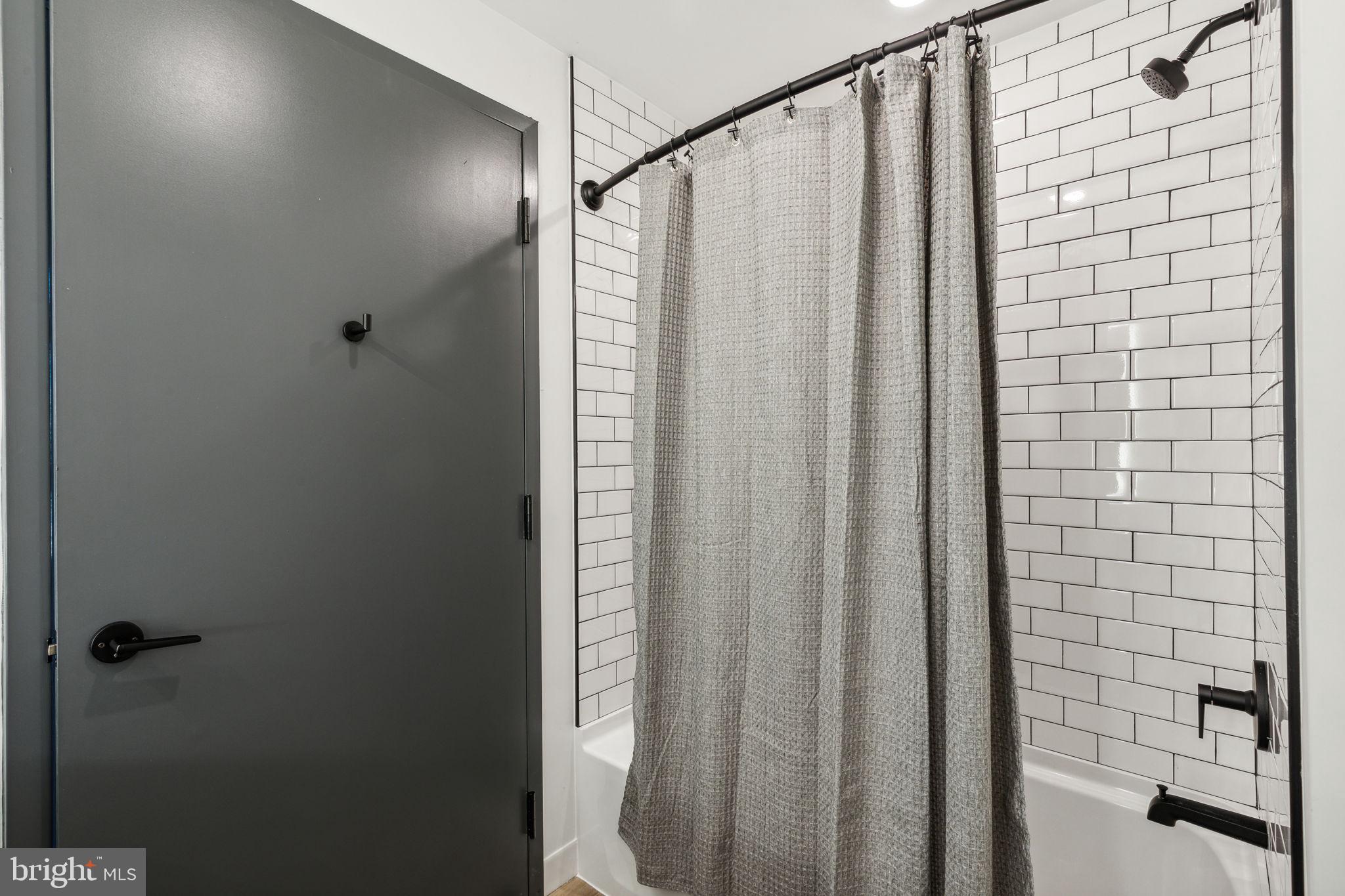 1122 Frankford Avenue, Unit STUDIO A2 Philadelphia, PA 19125 - Photo 28 of 45 a bathroom with a shower and a sink