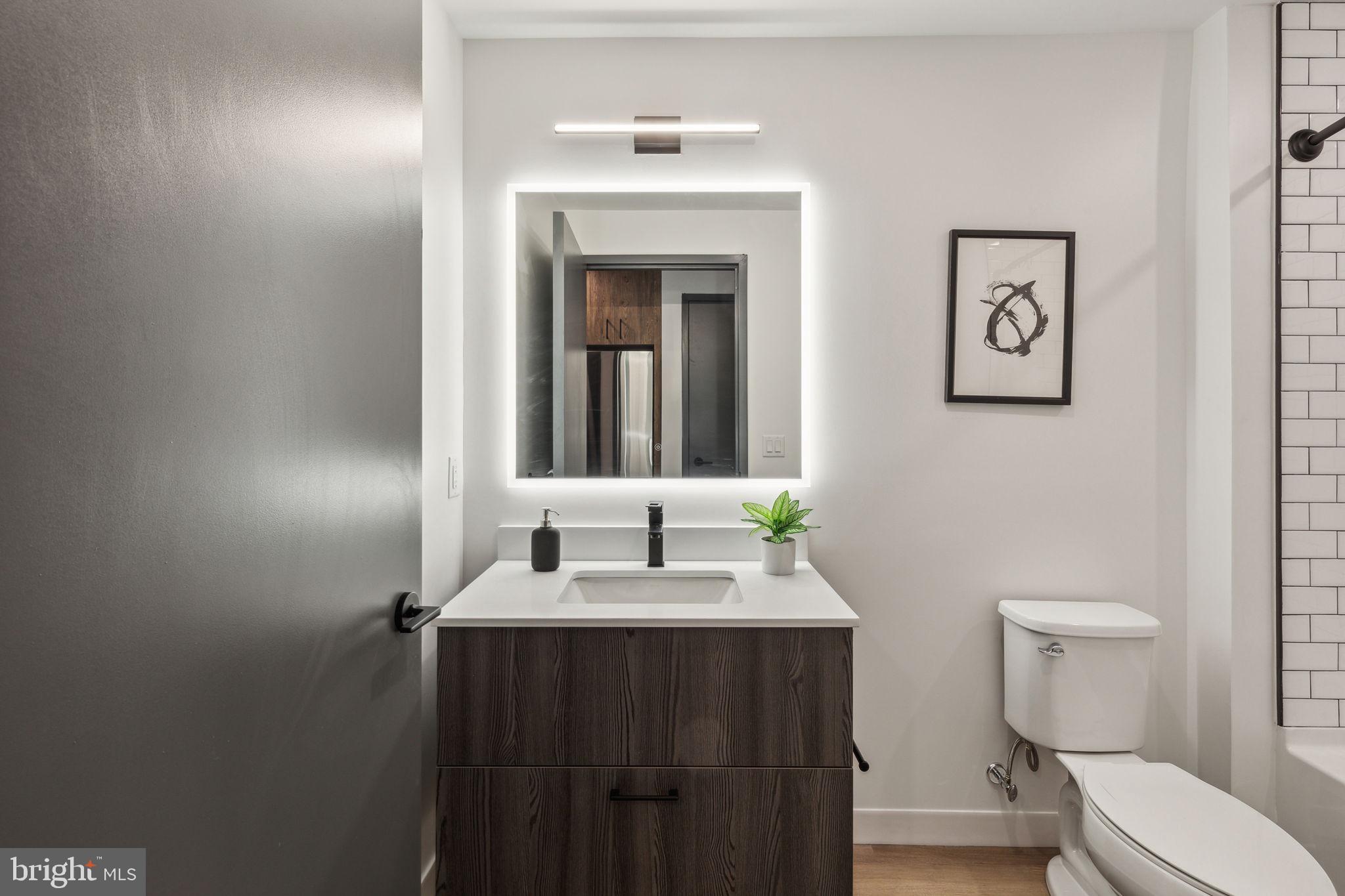 1122 Frankford Avenue, Unit STUDIO A2 Philadelphia, PA 19125 - Photo 29 of 45 a bathroom with a toilet sink and mirror