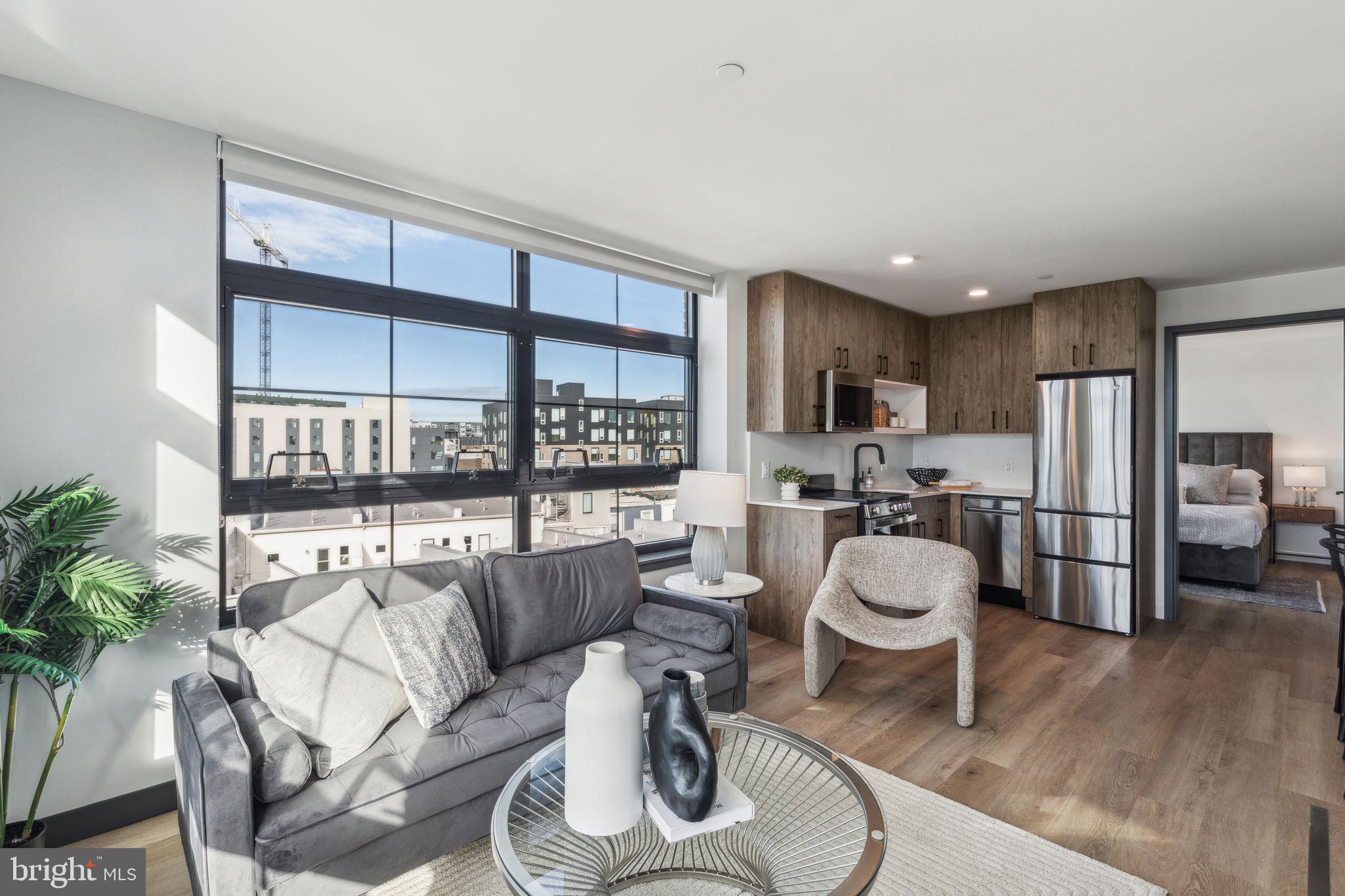 1122 Frankford Avenue, Unit STUDIO A2 Philadelphia, PA 19125 - Photo 30 of 45 a living room with stainless steel appliances furniture a rug and a kitchen view