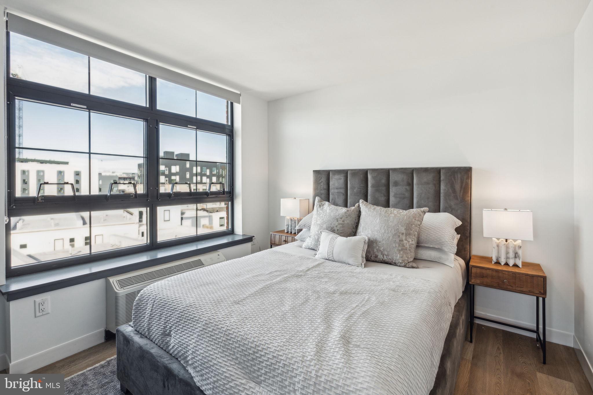 1122 Frankford Avenue, Unit STUDIO A2 Philadelphia, PA 19125 - Photo 35 of 45 a bedroom with a bed and a large window