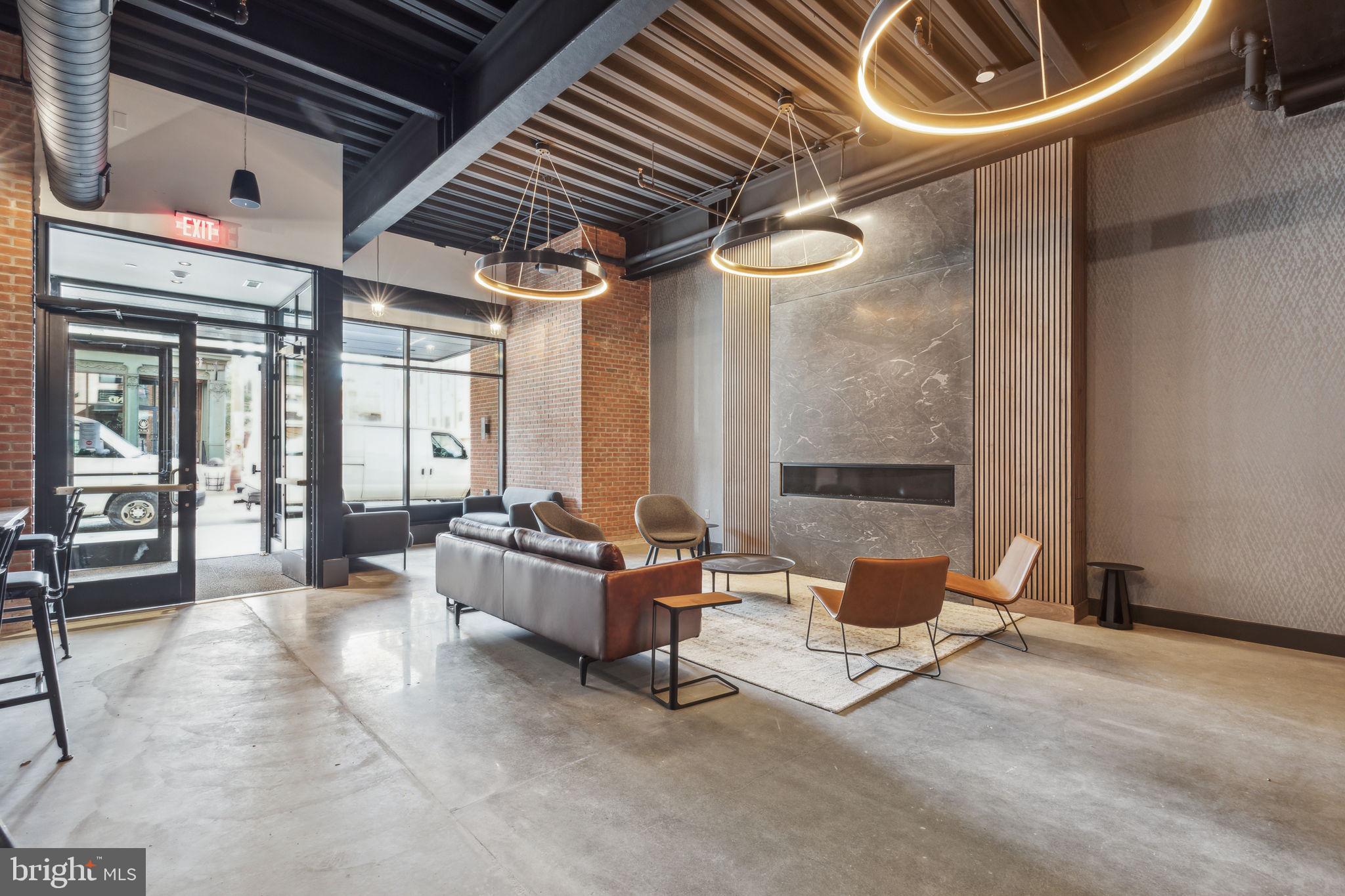 1122 Frankford Avenue, Unit STUDIO A2 Philadelphia, PA 19125 - Photo 42 of 45 a living room with furniture and a chandelier