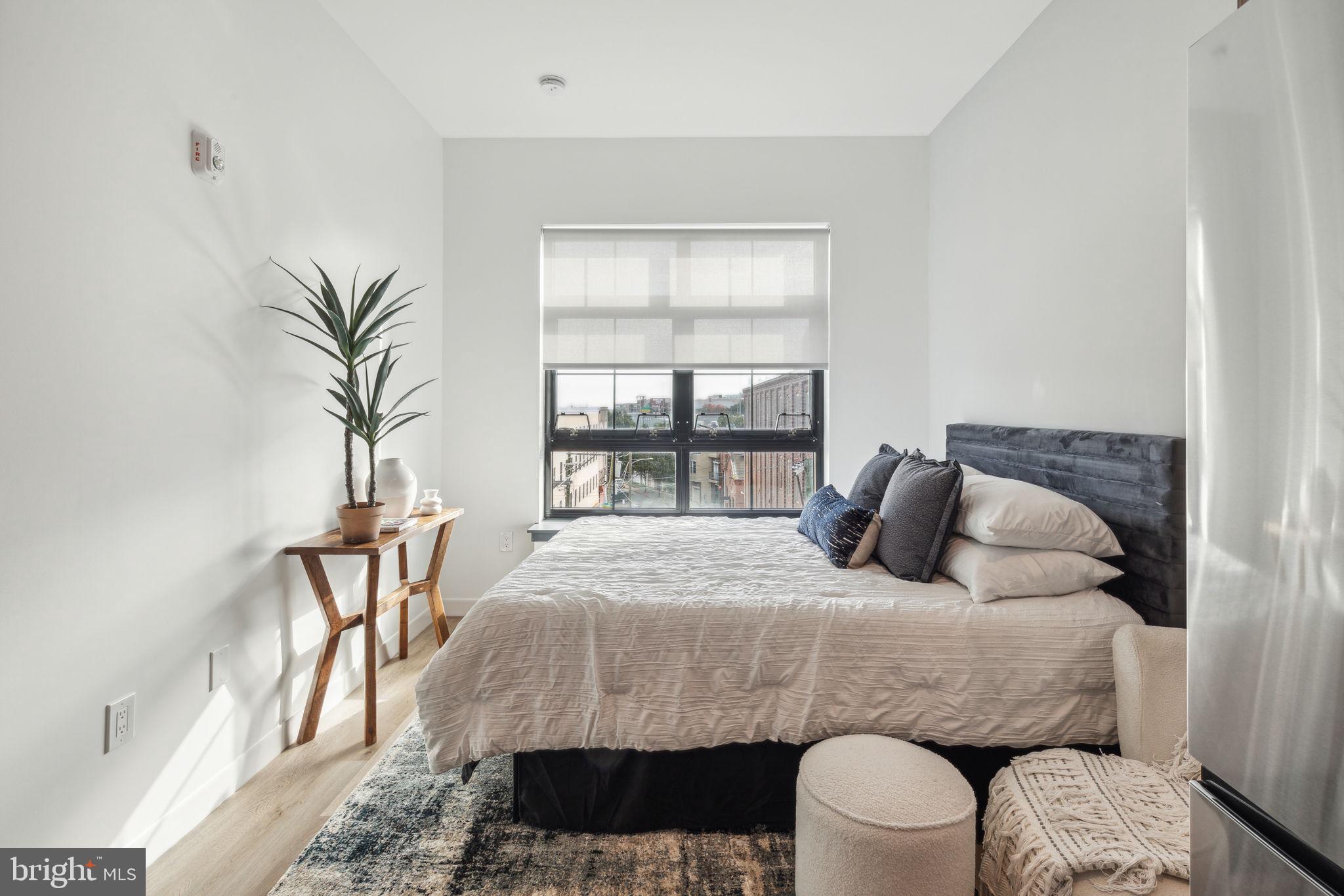 1122 Frankford Avenue, Unit STUDIO A2 Philadelphia, PA 19125 - Photo 5 of 45 a bedroom with a bed and a window