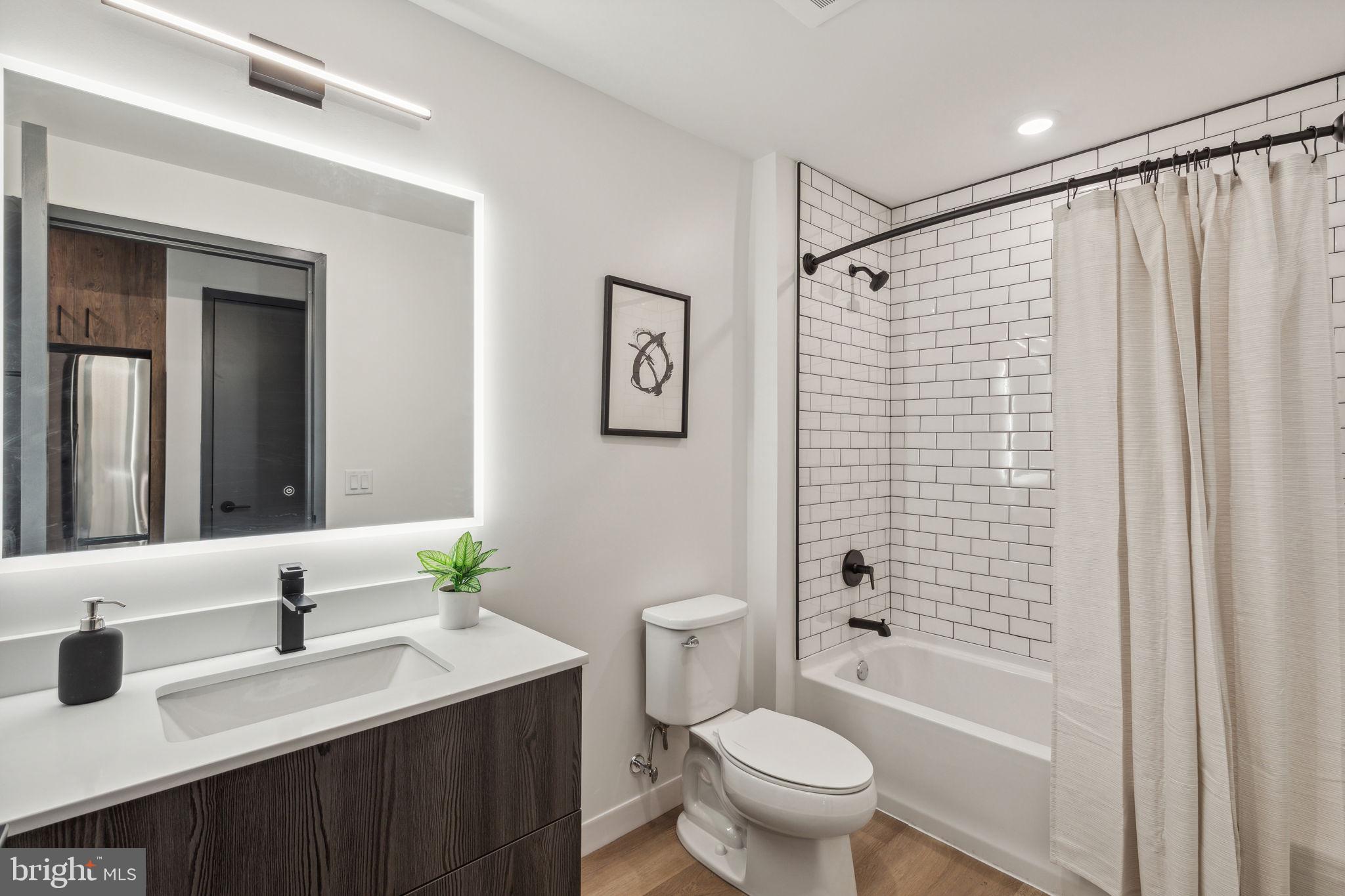 1122 Frankford Avenue, Unit STUDIO A2 Philadelphia, PA 19125 - Photo 6 of 45 a bathroom with a sink toilet and shower