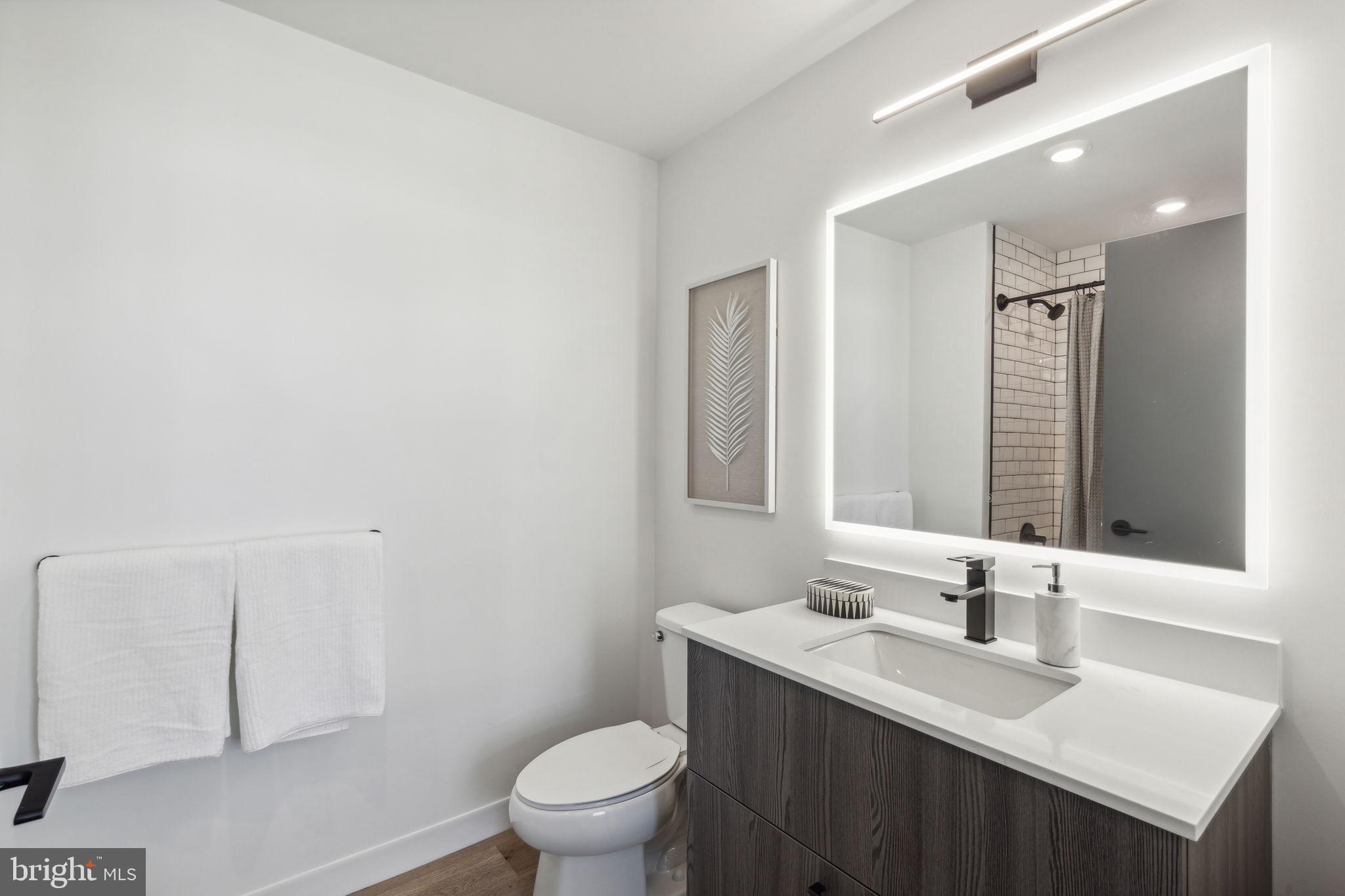 1122 Frankford Avenue, Unit STUDIO A2 Philadelphia, PA 19125 - Photo 7 of 45 a bathroom with a sink a toilet and mirror