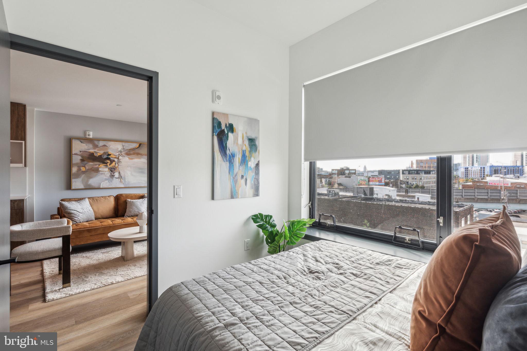 1122 Frankford Avenue, Unit STUDIO A2 Philadelphia, PA 19125 - Photo 10 of 45 a bedroom with furniture and a large window