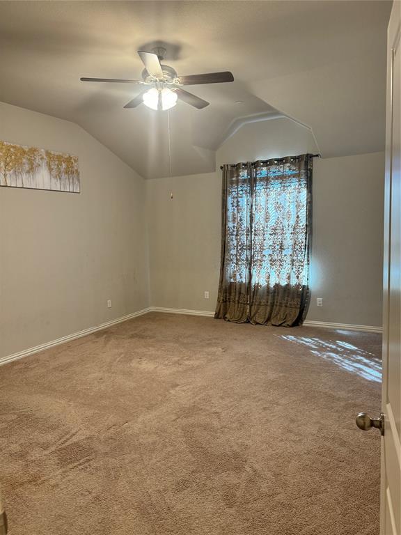 4475 Samarth Street Irving, TX 75061 - Photo 13 of 26 en empty room with windows and ceiling fan